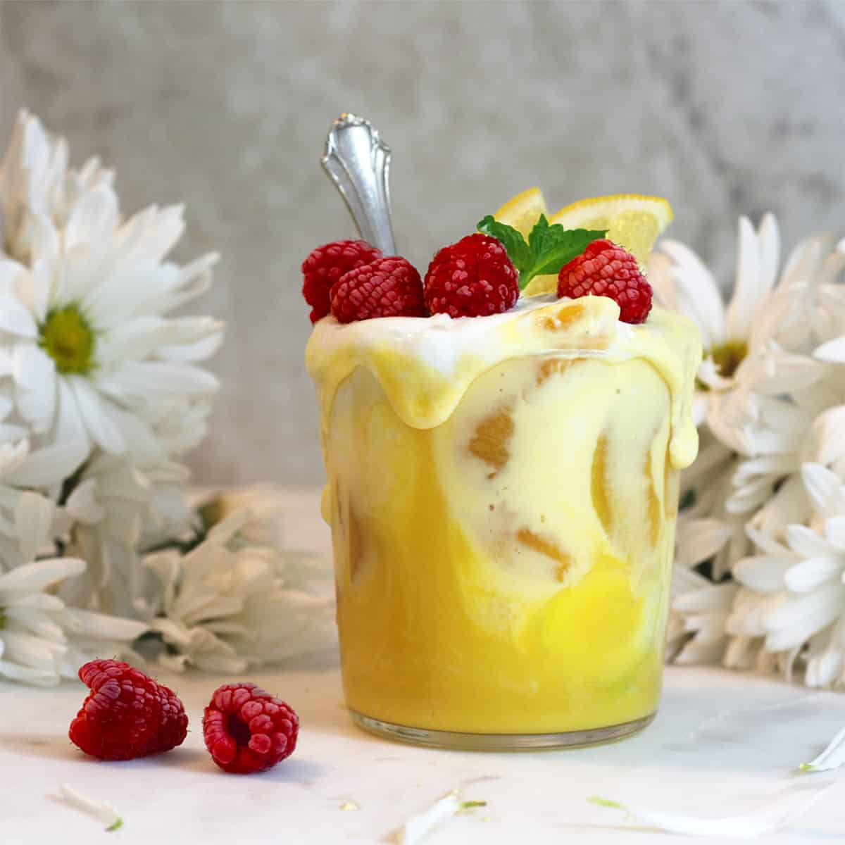 mango smoothie with raspberries on top