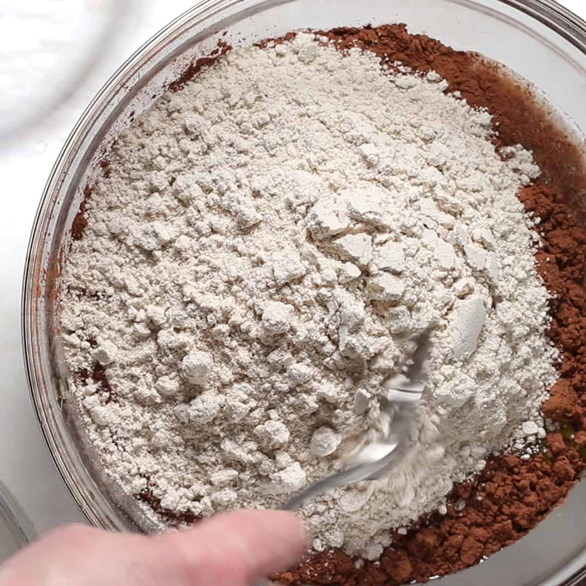 adding flour to bowl