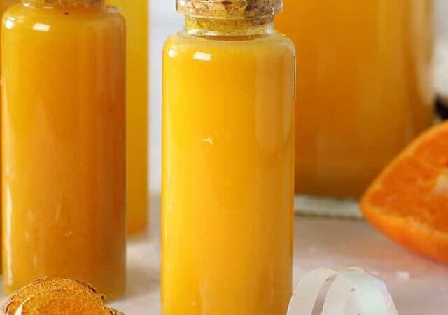 turmeric shots in shot glasses with an orange slice