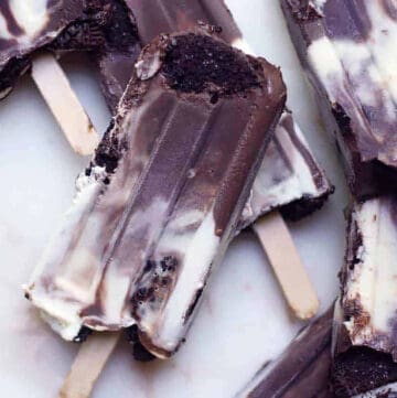 cookies and cream popsicles on a marble board