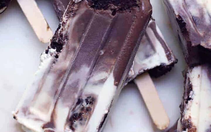 cookies and cream popsicles on a marble board