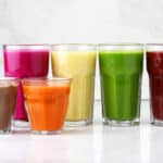 a row of smoothies in different colors and flavors