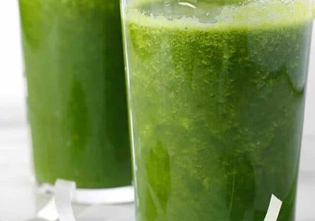 two glasses of green smoothie and a straw