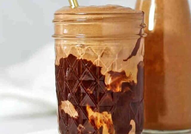 chocolate peanut butter smoothie with straw.