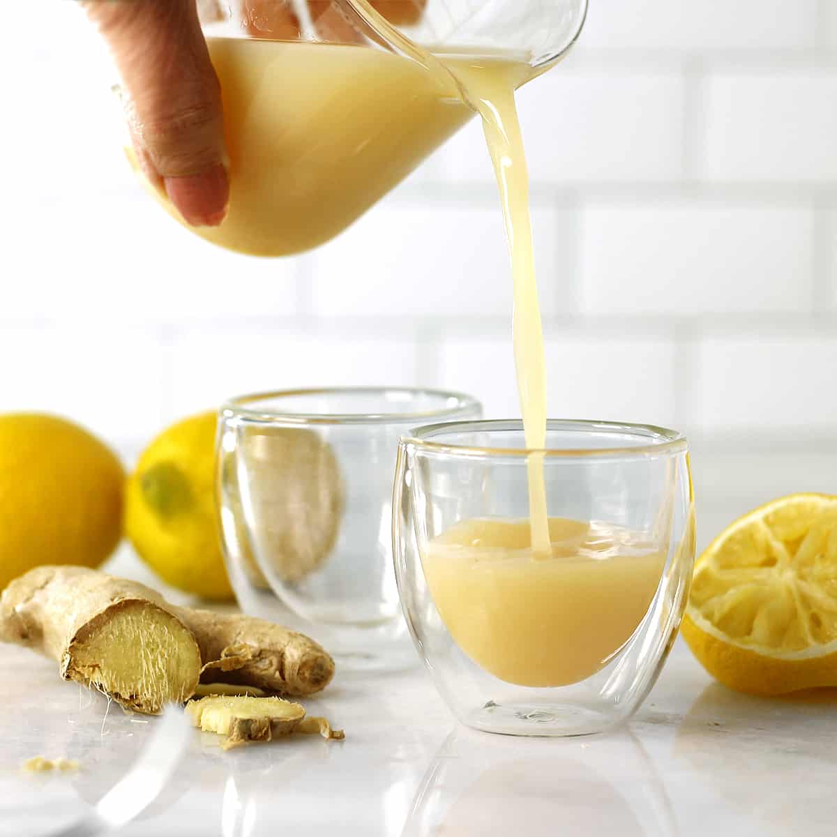 pour lemon ginger shots into shot glasses.