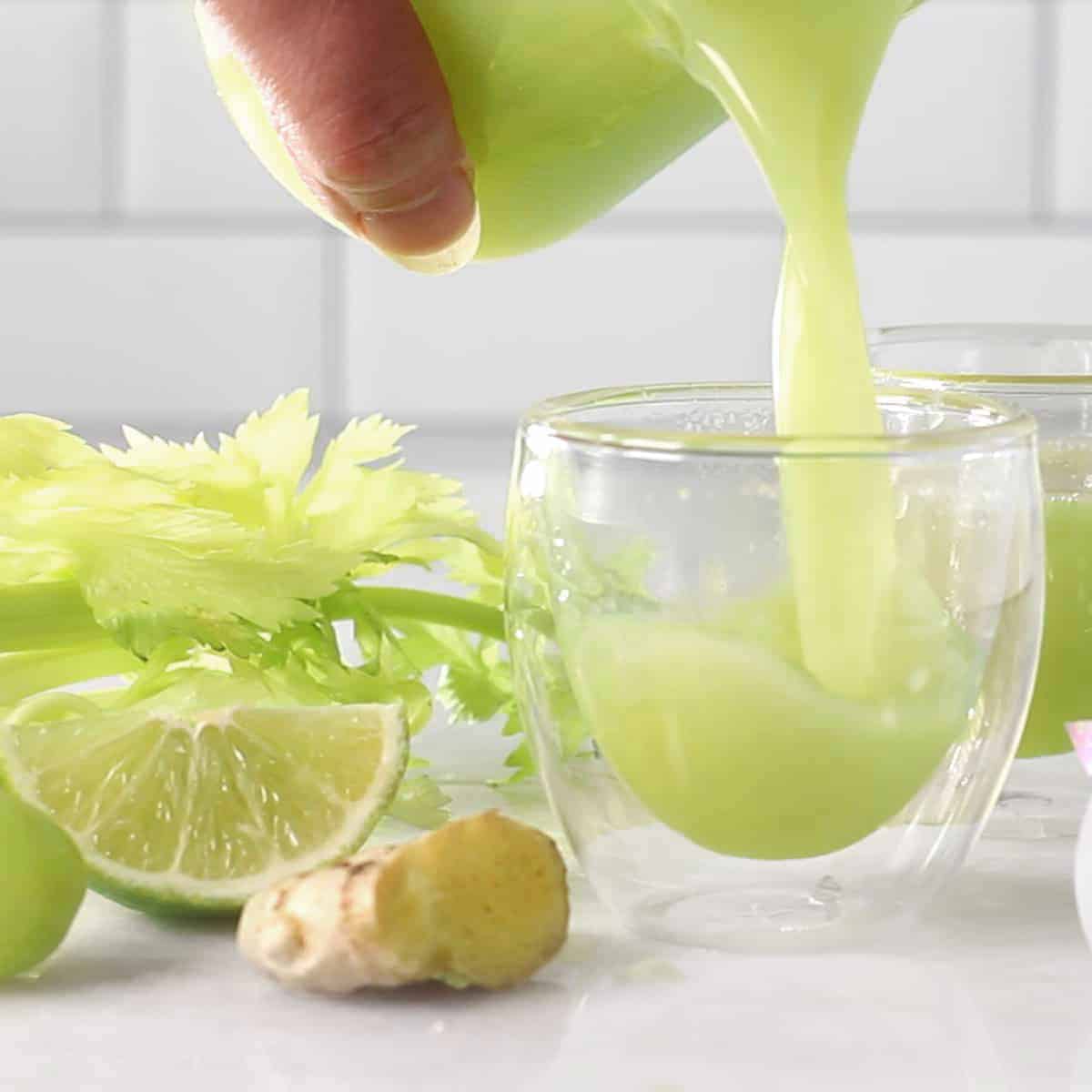 celery juice being poured into a glass.