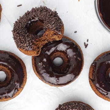 chocolate frosted donuts on marble board.