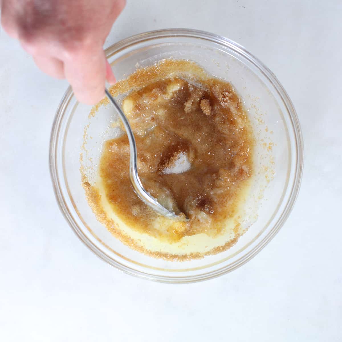 creaming sugar in a bowl with a spoon.