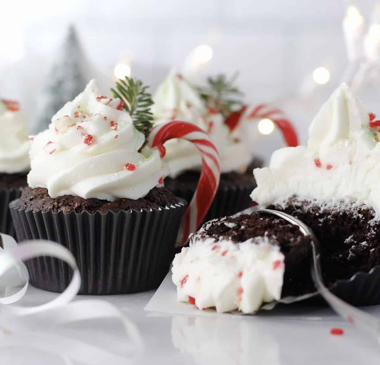 chocolate cupcake with white frosting and candy cane