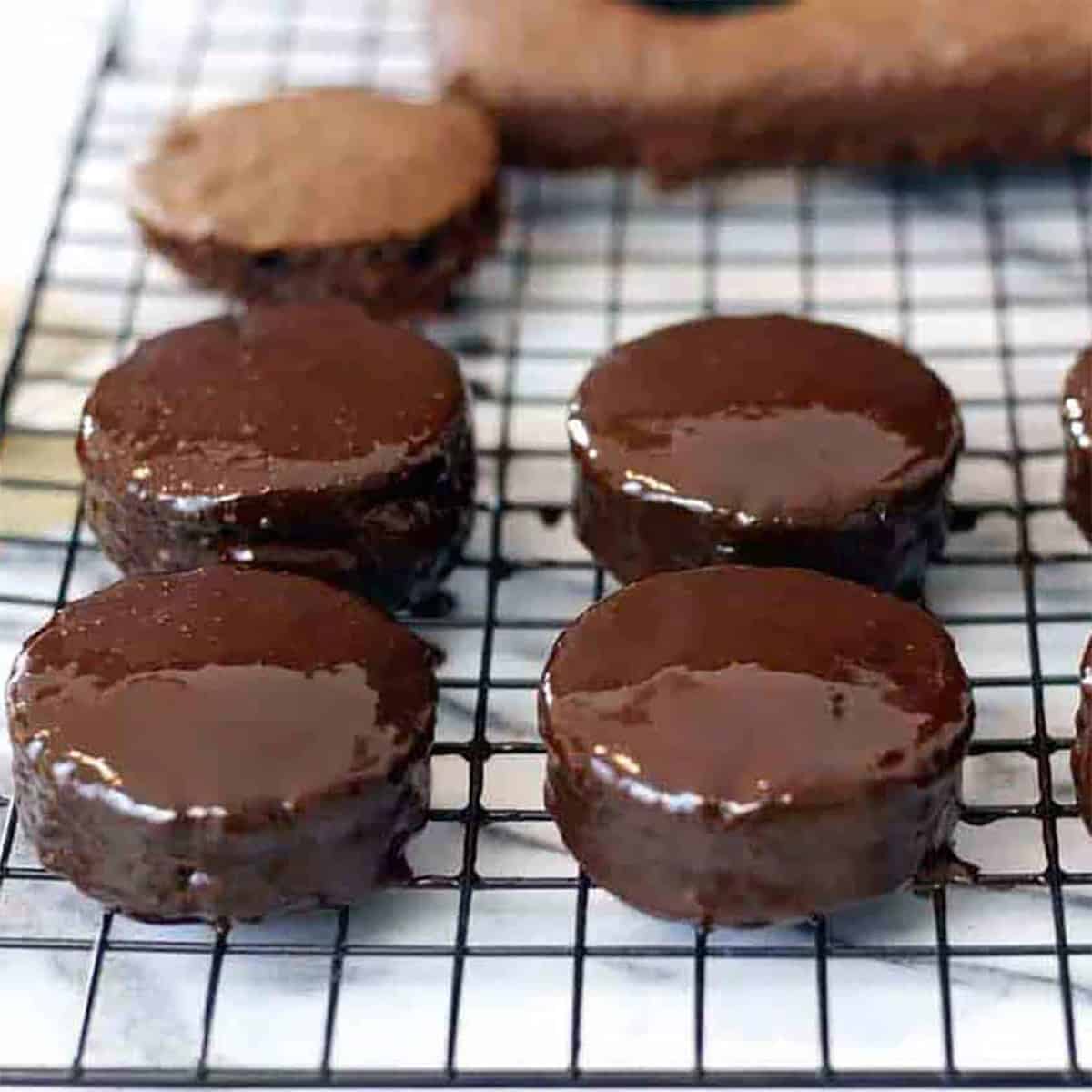 ring dings on a chocolate rack.