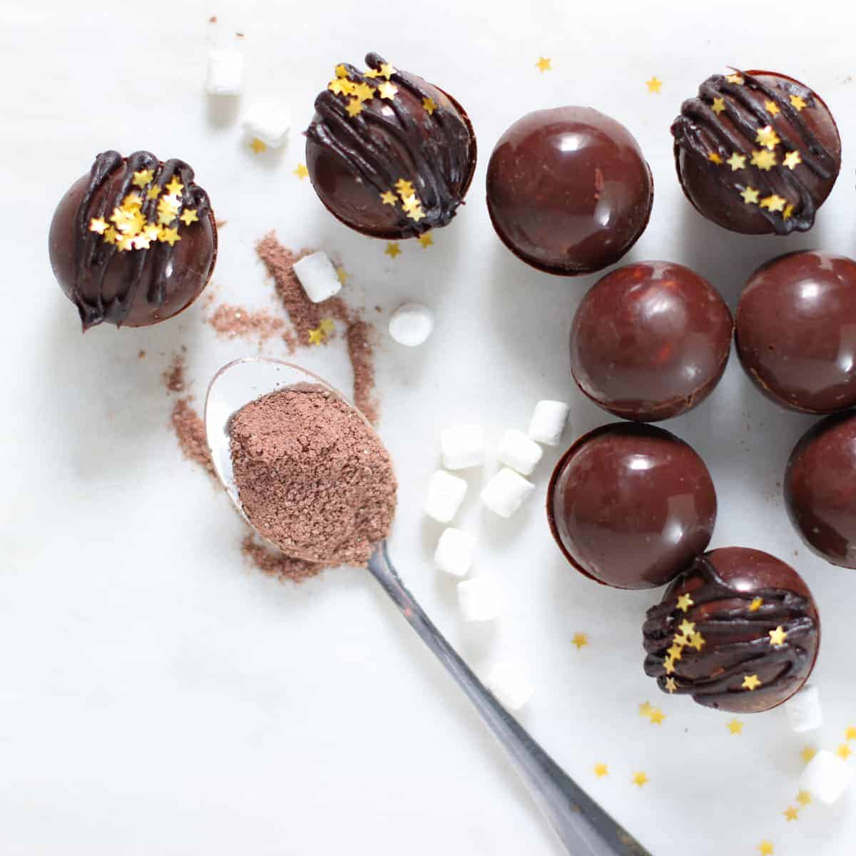 mini hot chocolate bombs with spoonful of cocoa