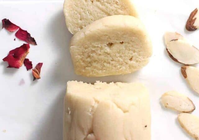 a log of marzipan sliced with rose petals