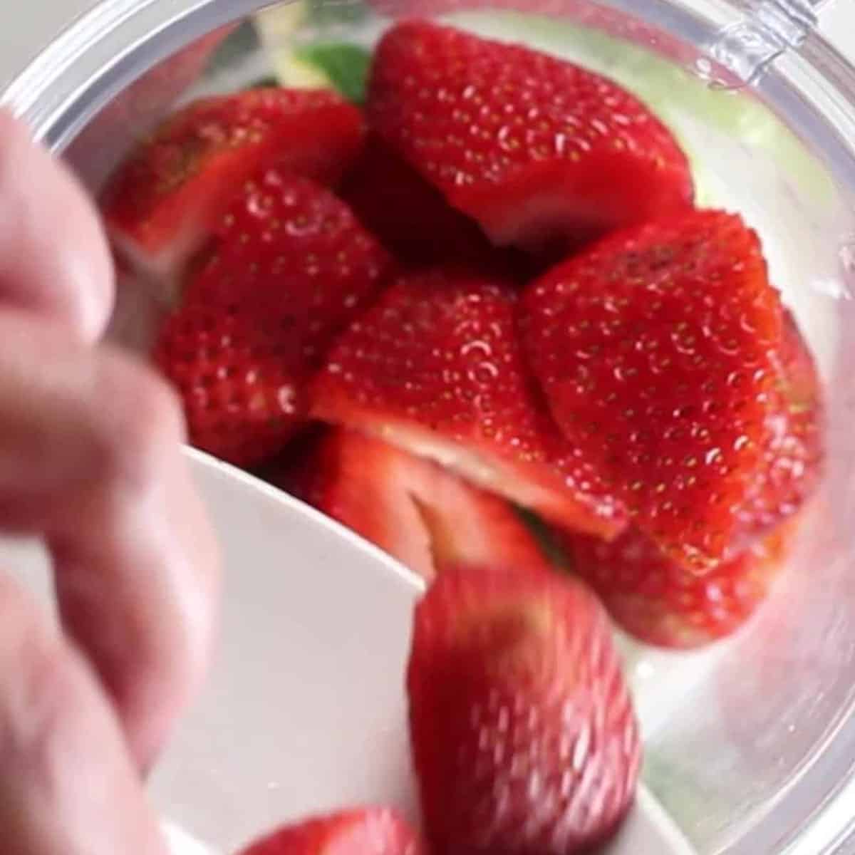 strawberries added to a blender.