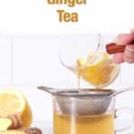 ginger tea being poured into a strainer into a cup