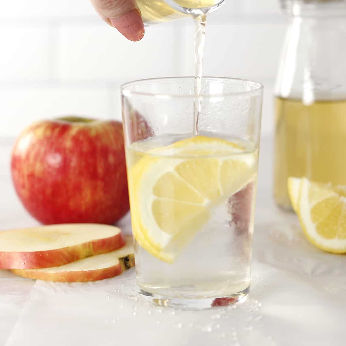 apple cider vinegar drink with an apple and frother