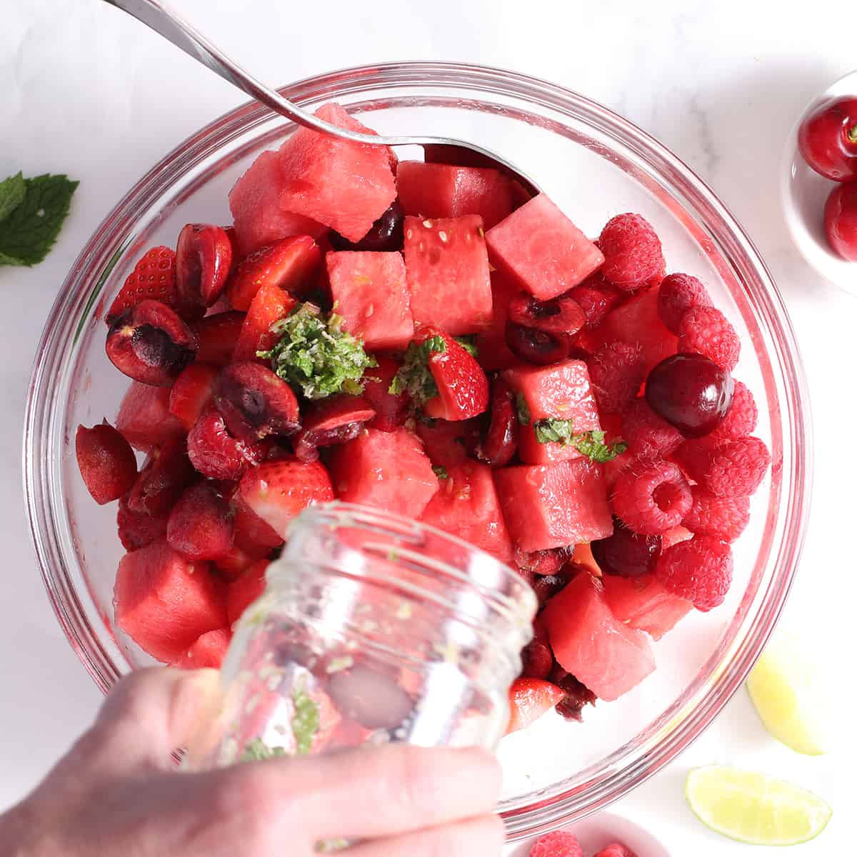 dressing in a jar poured into watermelon salad