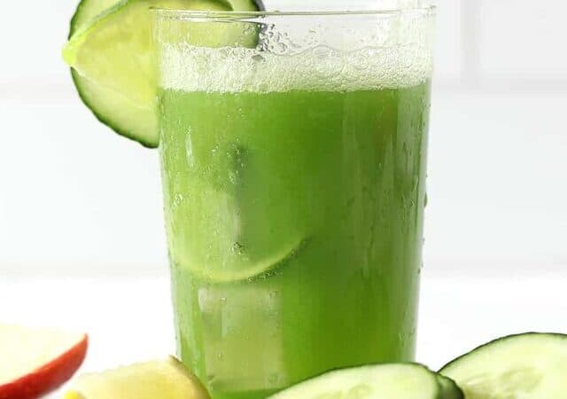 cucumber juice with foam top and sliced cucumbers