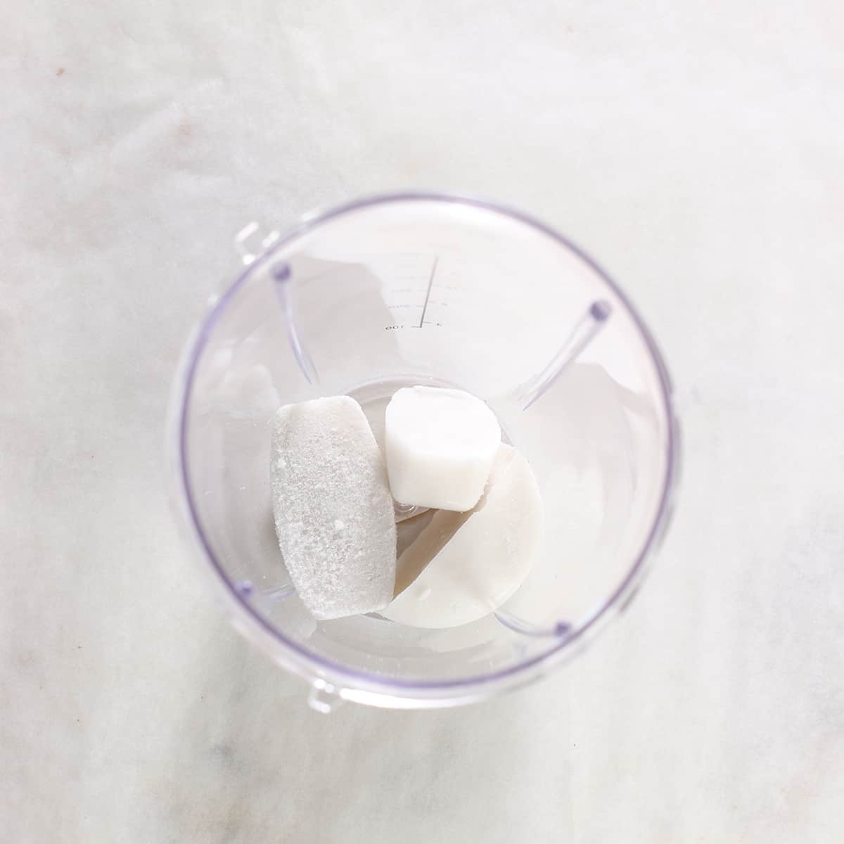 frozen milk cubes in blender to make chocolate smoothie.