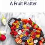 fruit platter on a black pan with roses