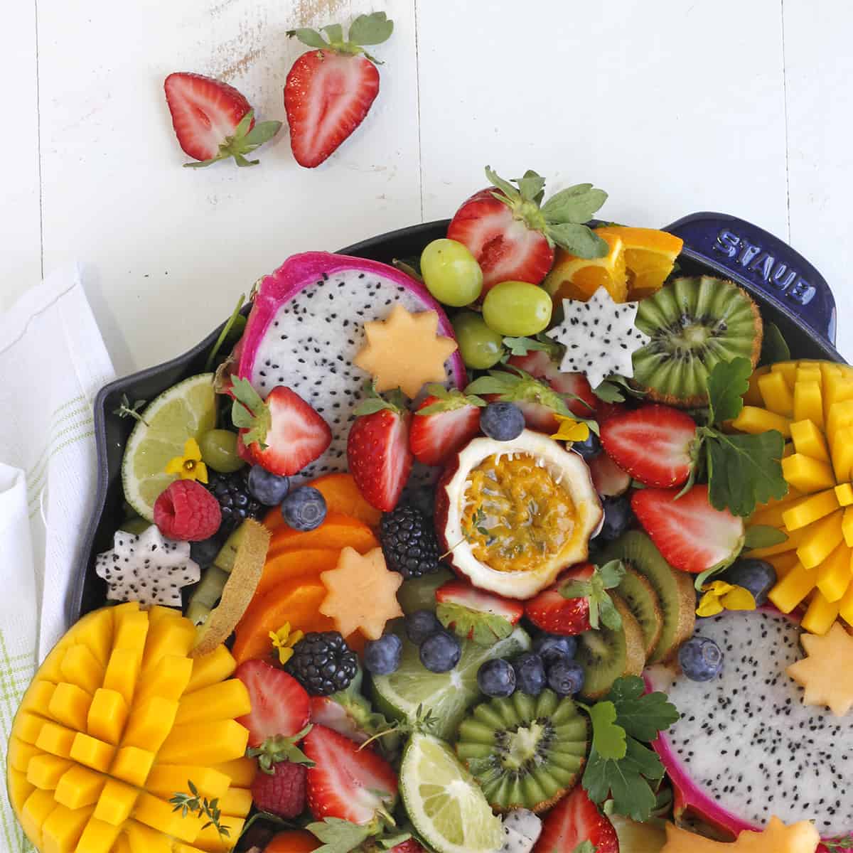 a fruit platter with passion fruit and mango
