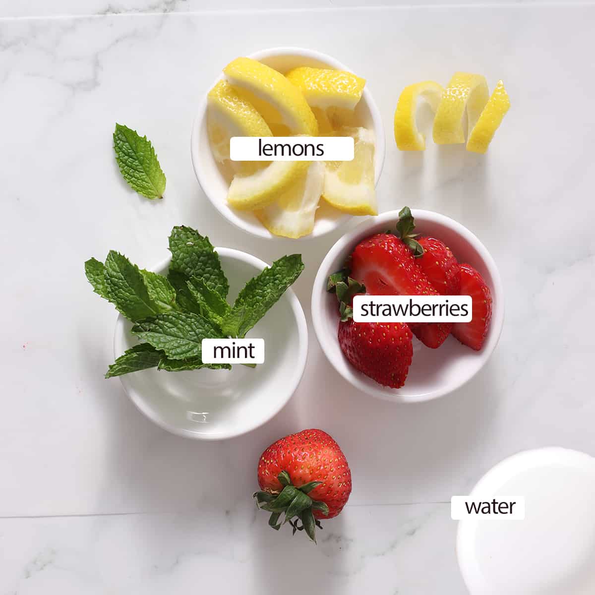 labeled ingredients for strawberry lemon water.