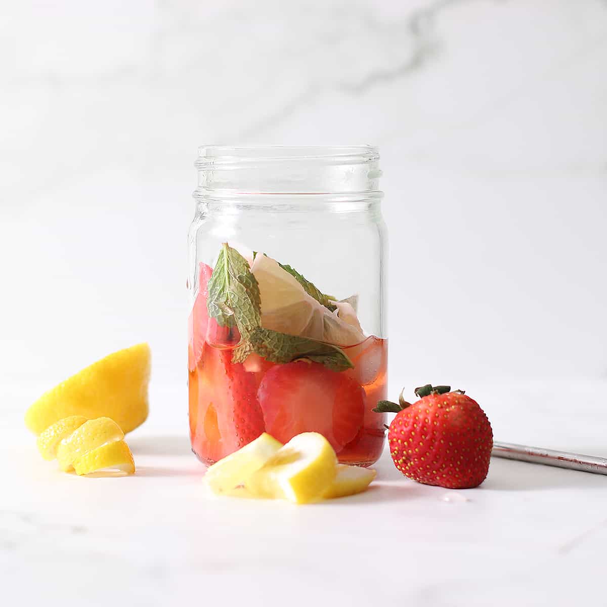 fruit from strawberry water in a jar.