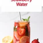 strawberry water in a jar with a metal straw