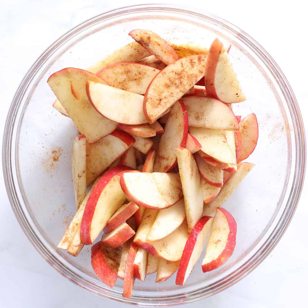 sliced apples with cinnamon in a bowl.