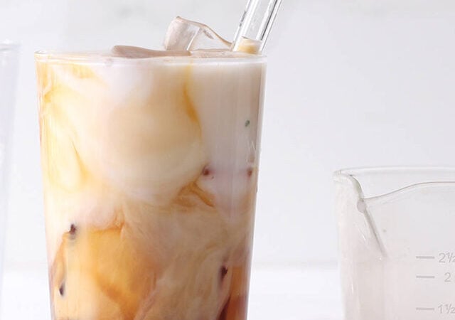 homemade iced coffee in a glass with a straw.