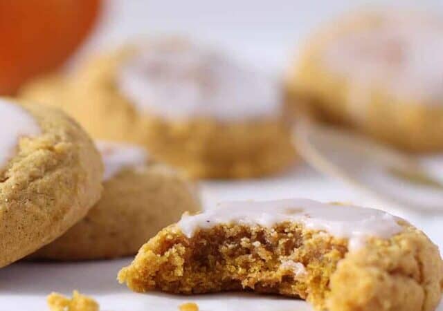 pumpkin sugar cookies that are frosted.