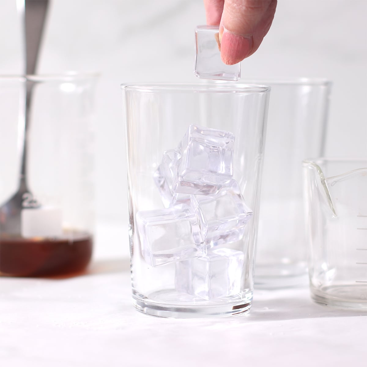 adding ice to a glass for iced coffee.