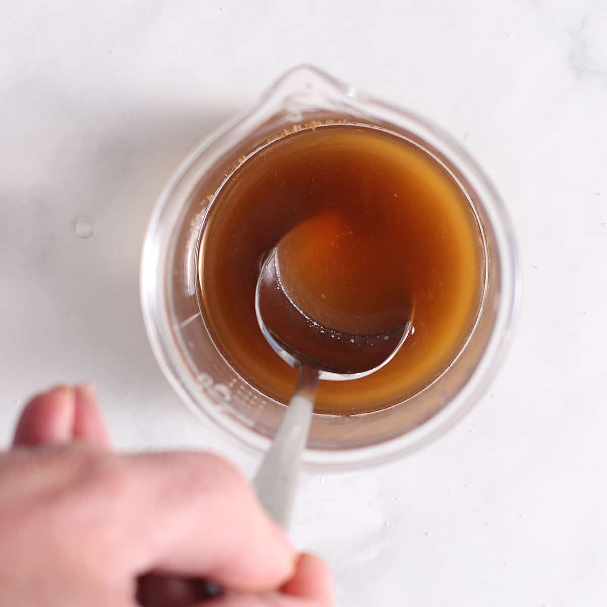 overhead of simple vanilla syrup in a cup.