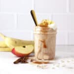 apple banana smoothie with a slice apple.