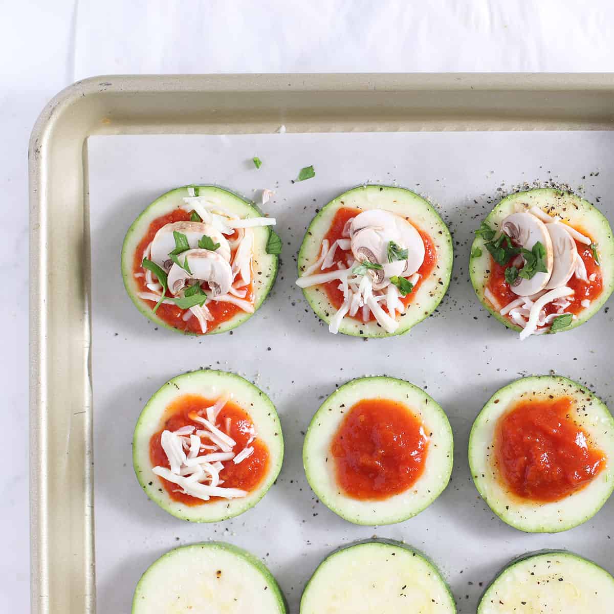 zucchini pizza bites with toppings.