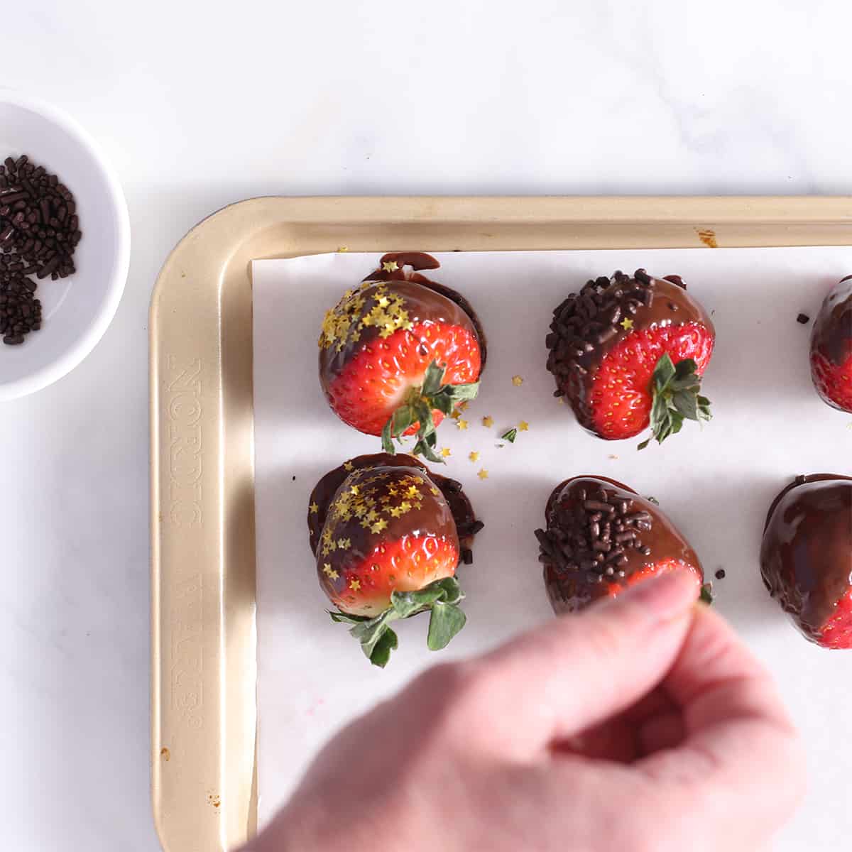 dipped chocolate covered strawberries on a tray.