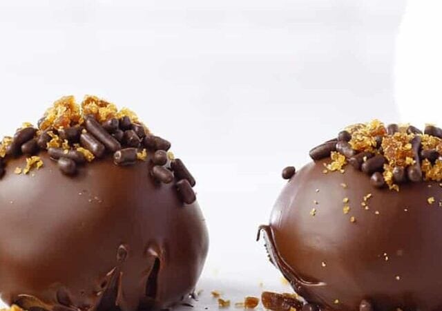 two chocolate pralines on a table.