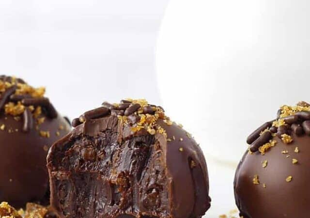 three chocolate pralines on a table.