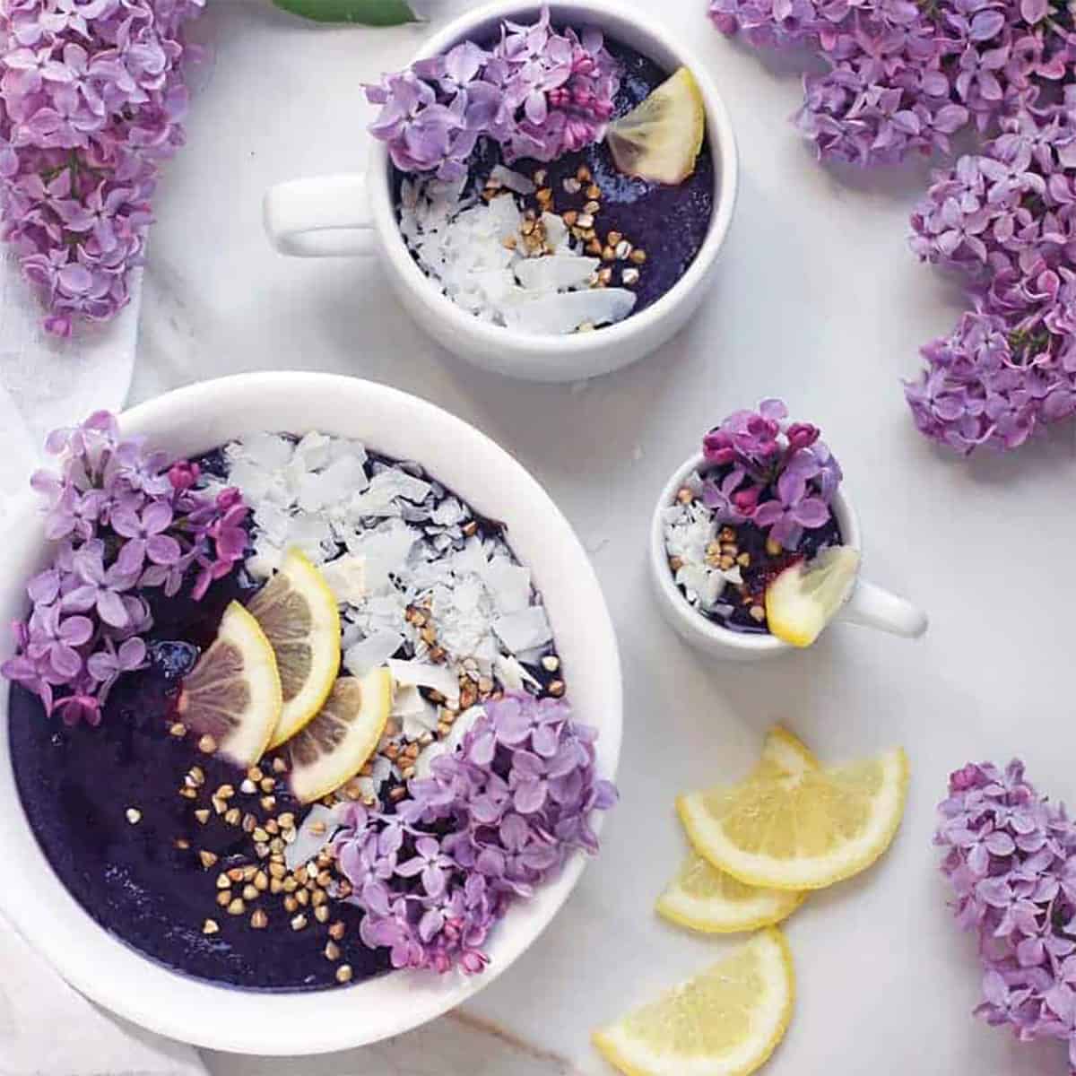 foods that are purple bowl of smoothie and flowers.