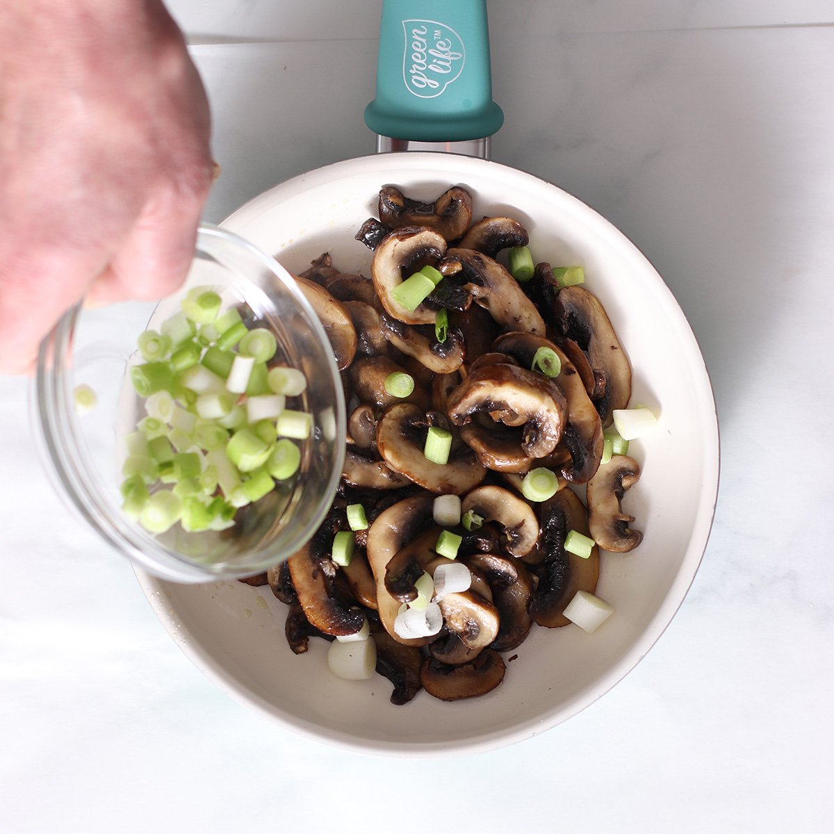 add scallions to sauteed mushrooms.
