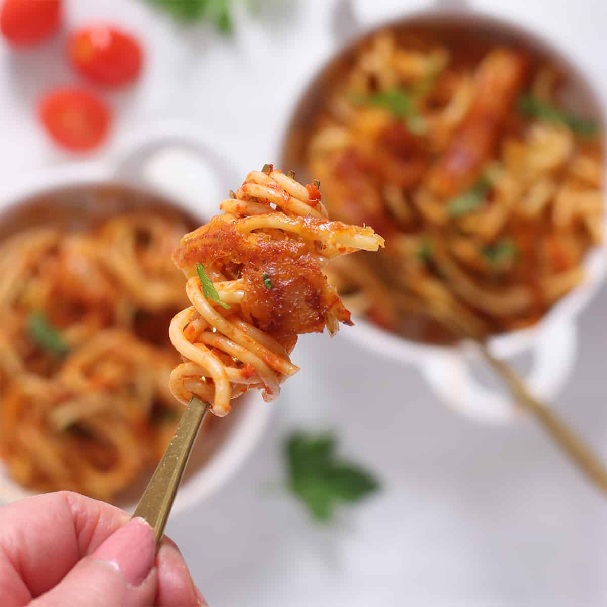 a forkful of fried spaghetti with crispy melted cheese.