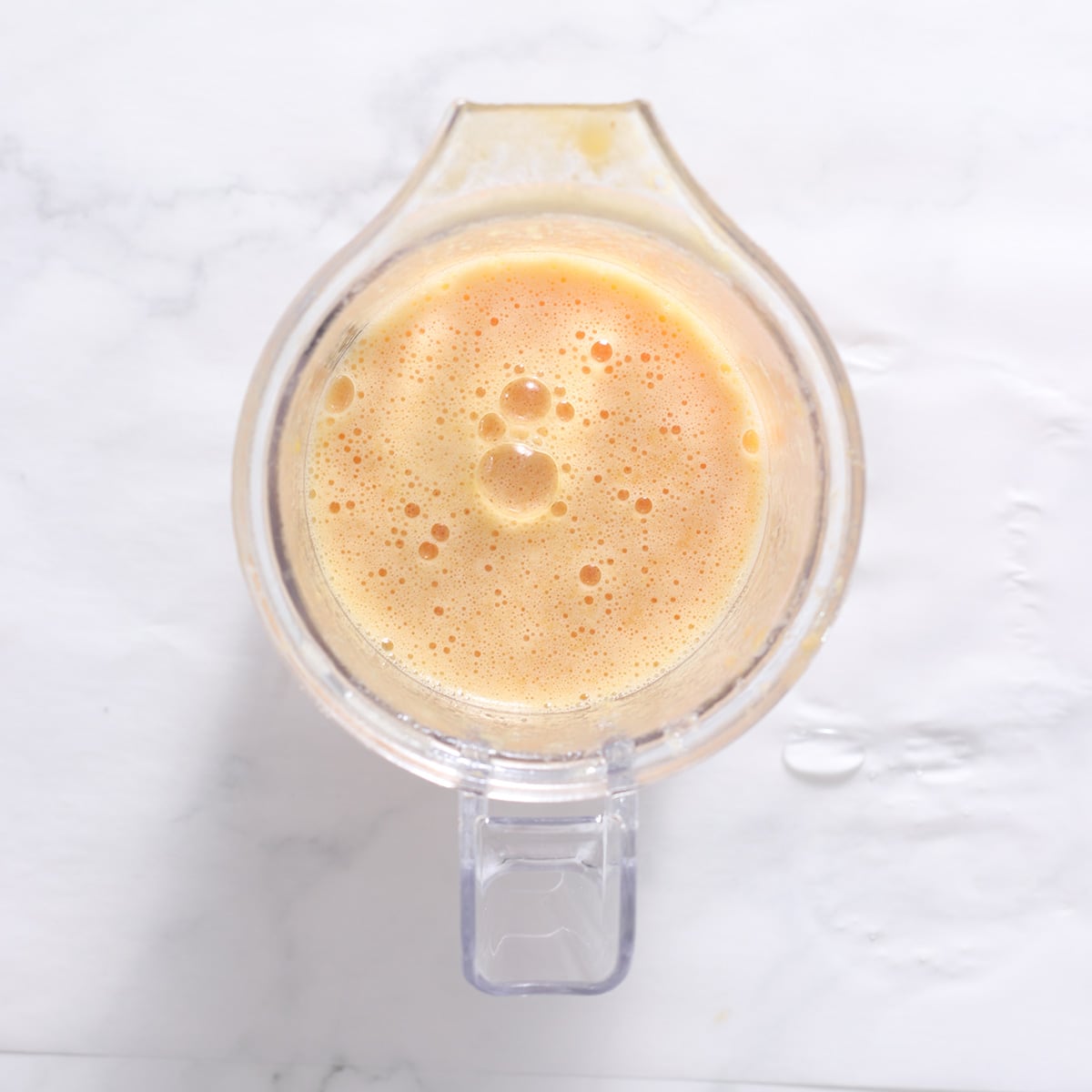 orange smoothie in a glass.