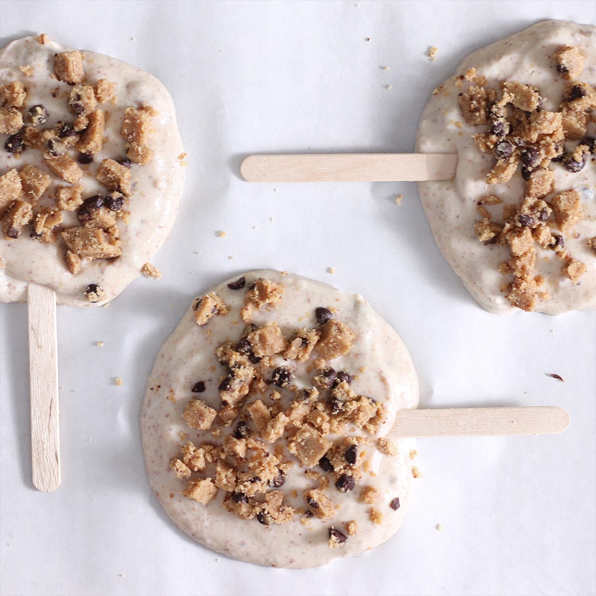 cookie dough frozen yogurt bar batter with bits of cookie dough sprinkled on top.
