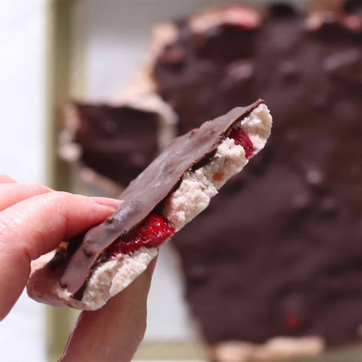 strawberry frozen yogurt cookie dough in a hand.