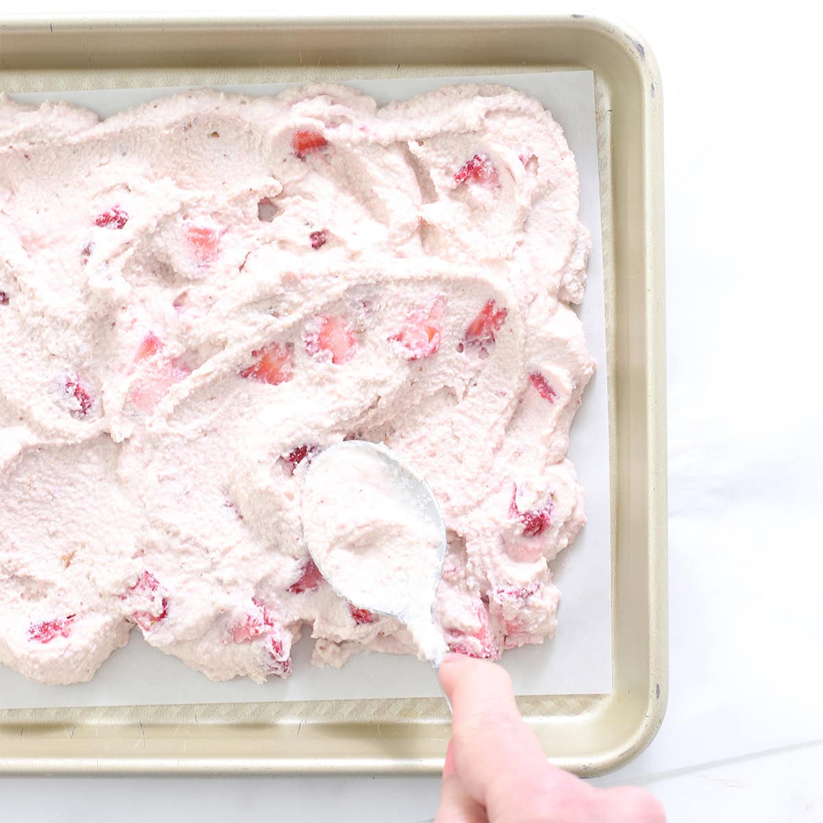 strawberry frozen yogurt cookie dough spread in pan.