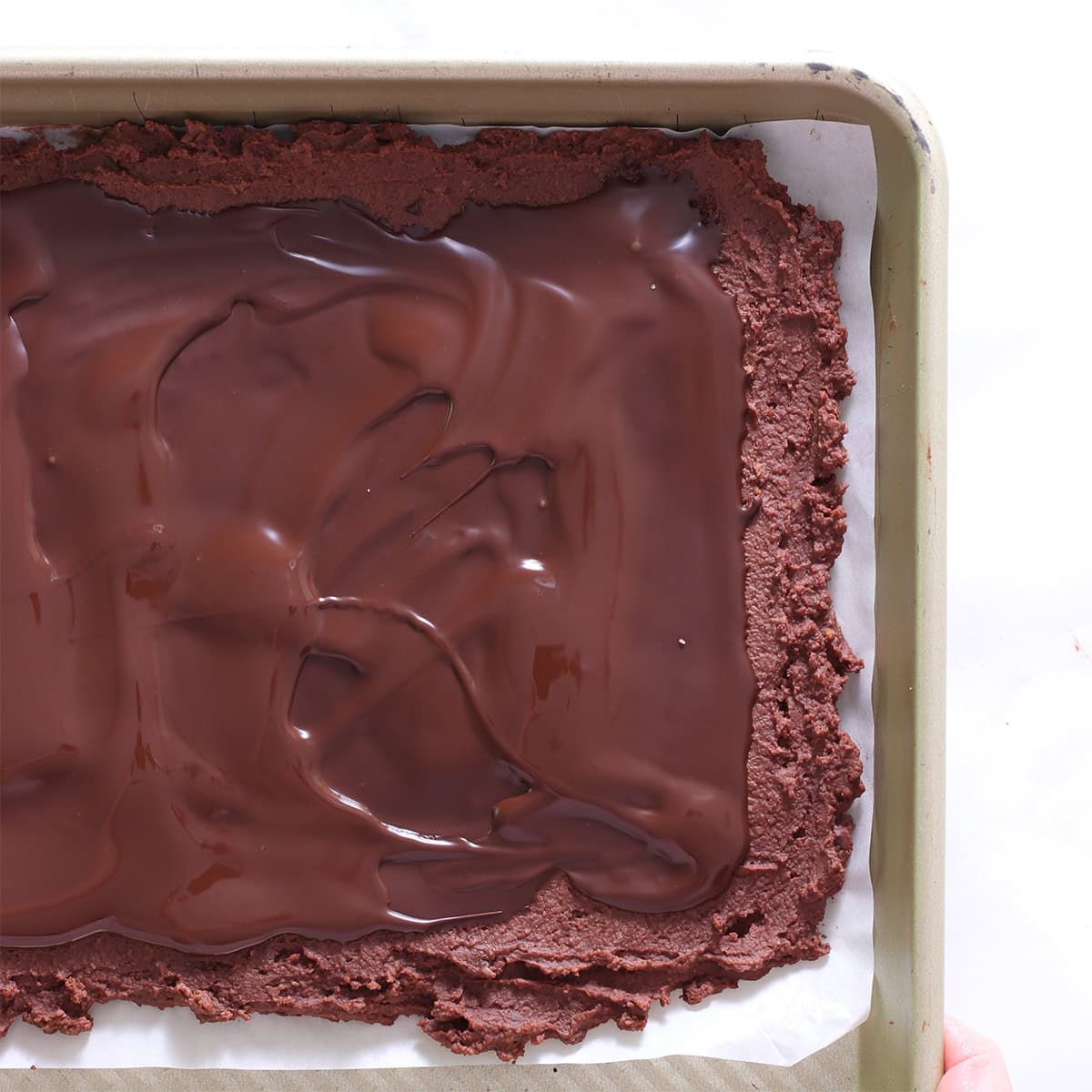 brownie batter with chocolate icing spread.