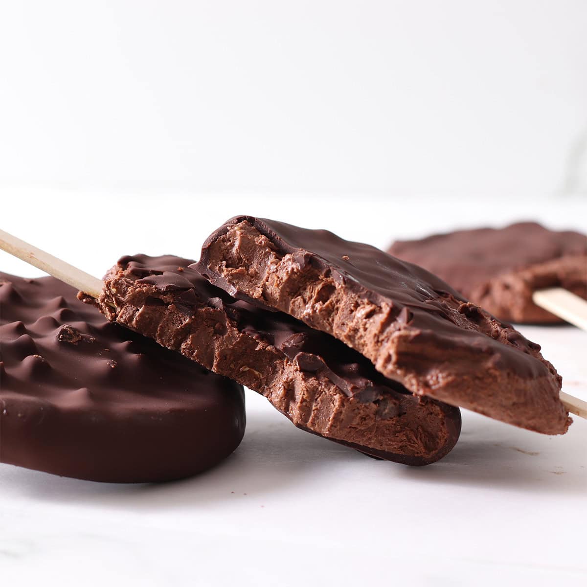 chocolate frozen yogurt pops on a pile.