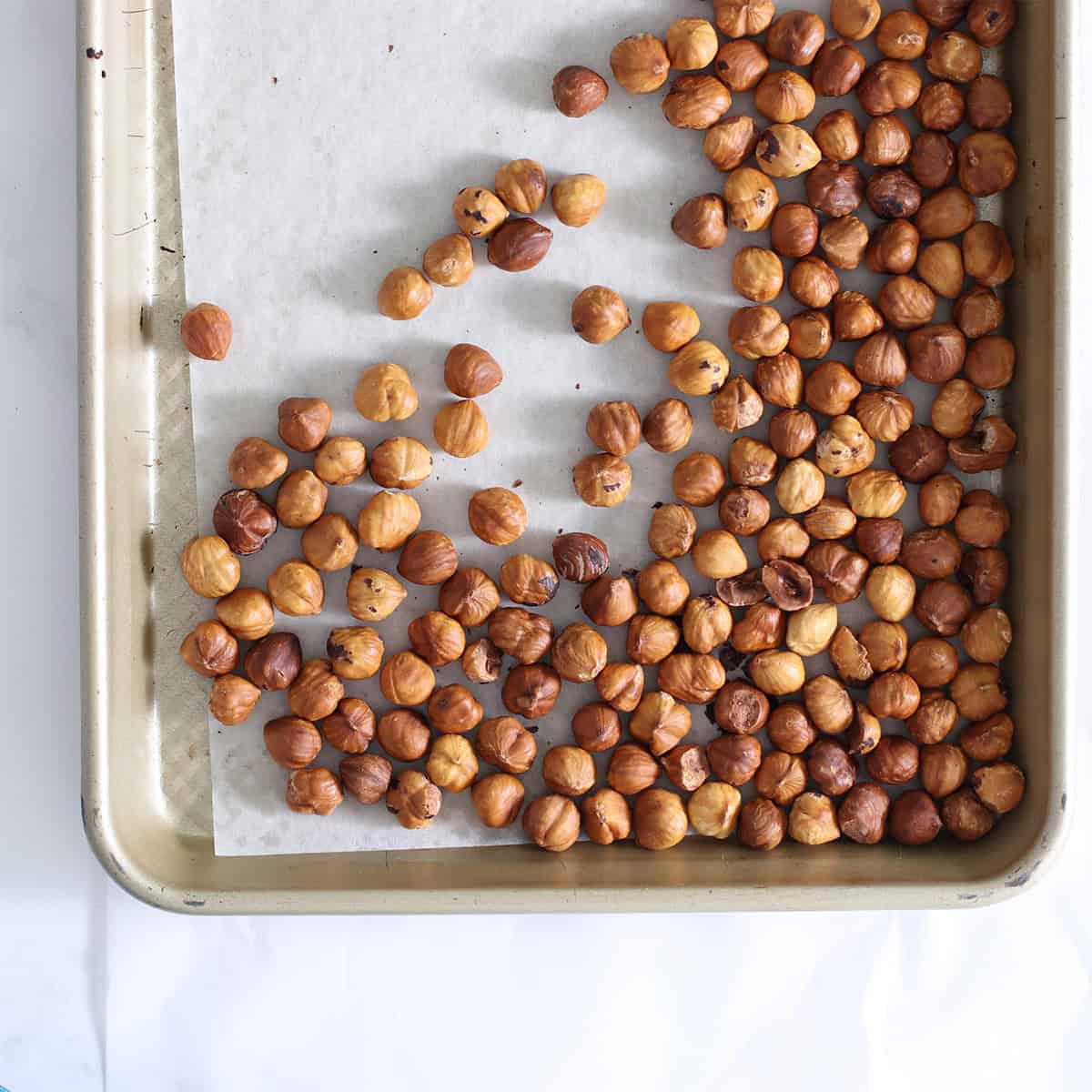 roasted hazelnuts on a tray.