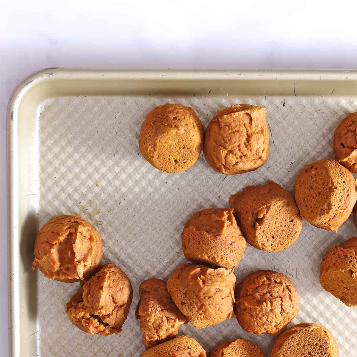 pumpkin donut holes baked in pan.