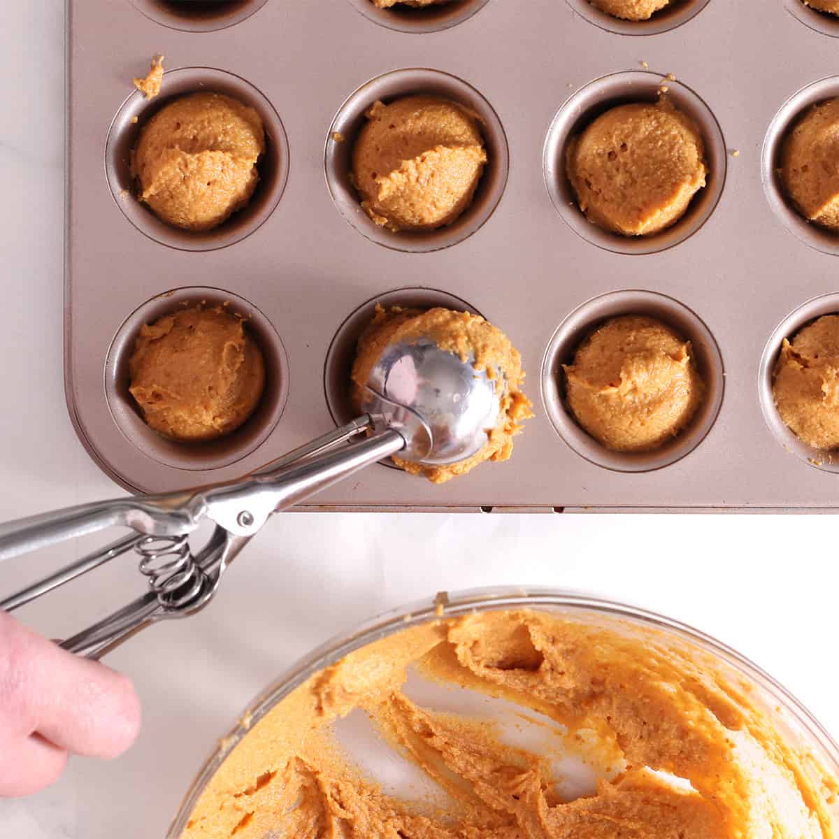 scoop the pumpkin donut holes into a pan.