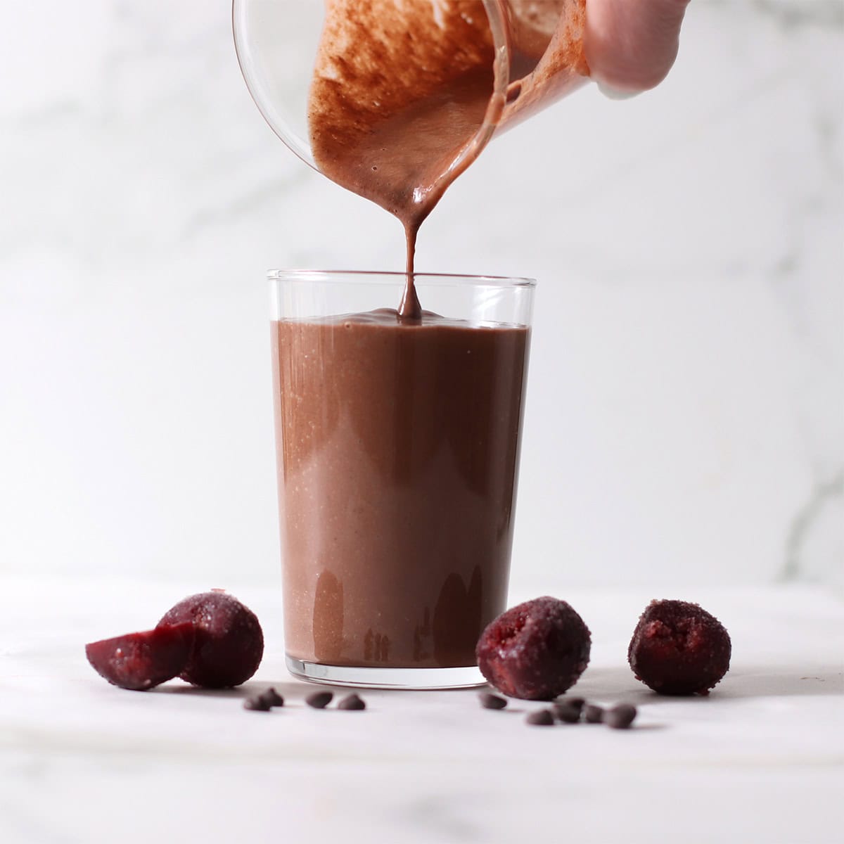 pouring black forest and chocolate cherry smoothie.